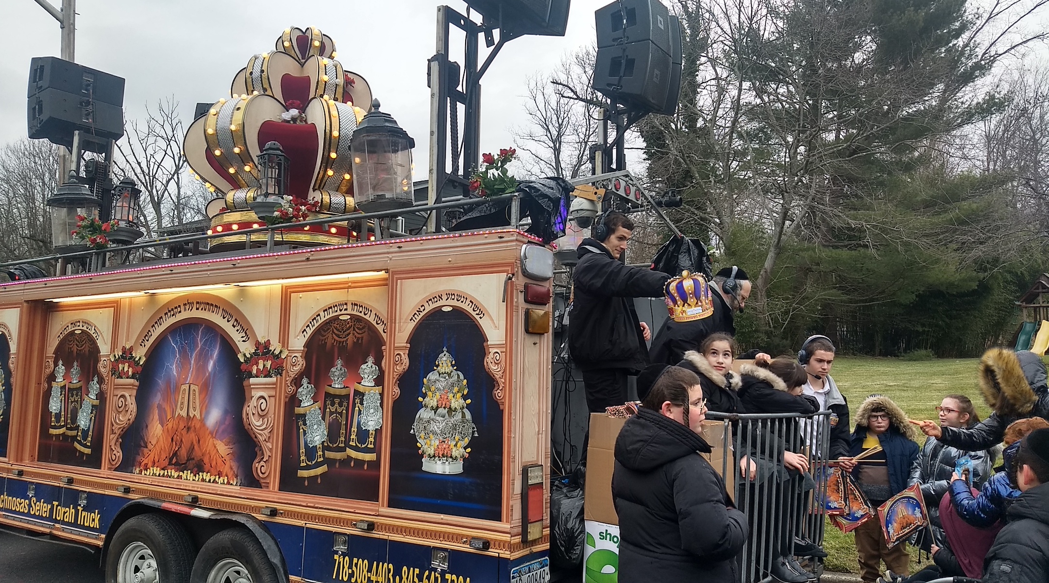 On Sunday afternoon, blocks away from the site of the previous night's stabbing, Jewish children gathered near a parade float to celebrate the dedication of a new Torah scroll. (Ben Sales)