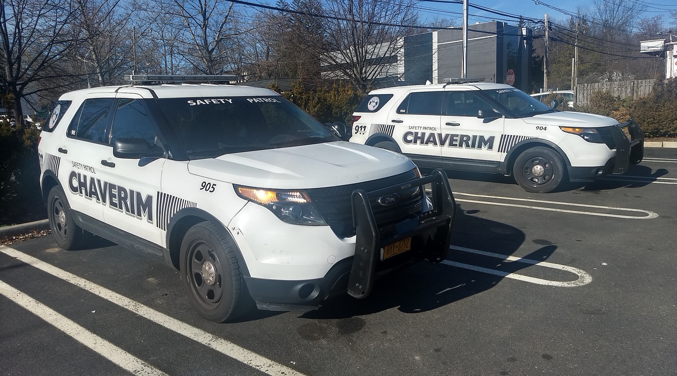 Two of Chaverim's SUVs, equipped with sirens and insignia. (Ben Sales)