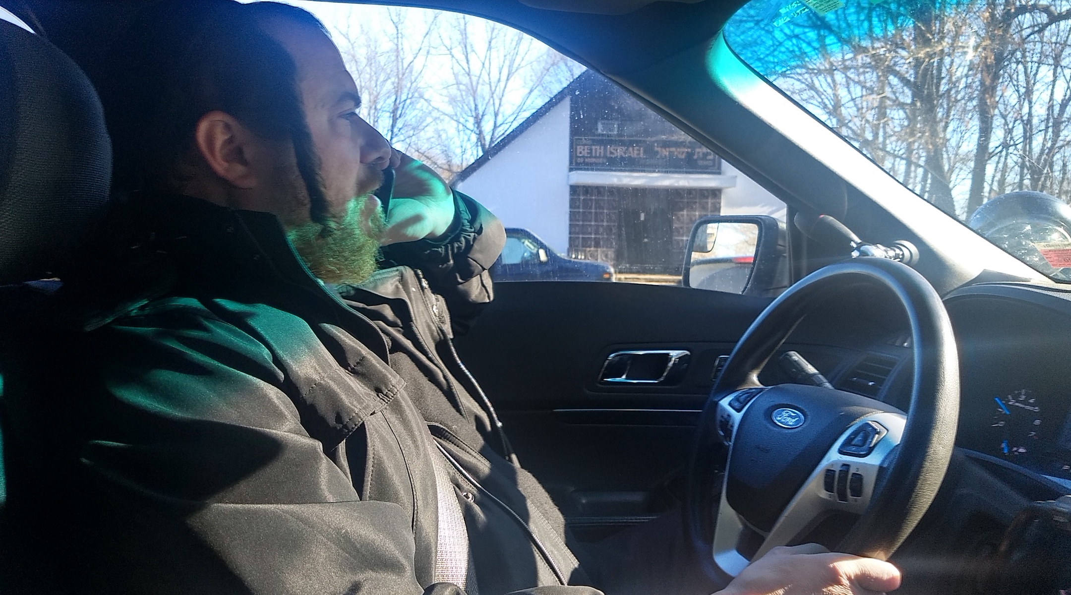 Josef Margaretten speaks on the phone as he patrols Monsey, N.Y. for the Chaverim on January 9, 2020. (Ben Sales)