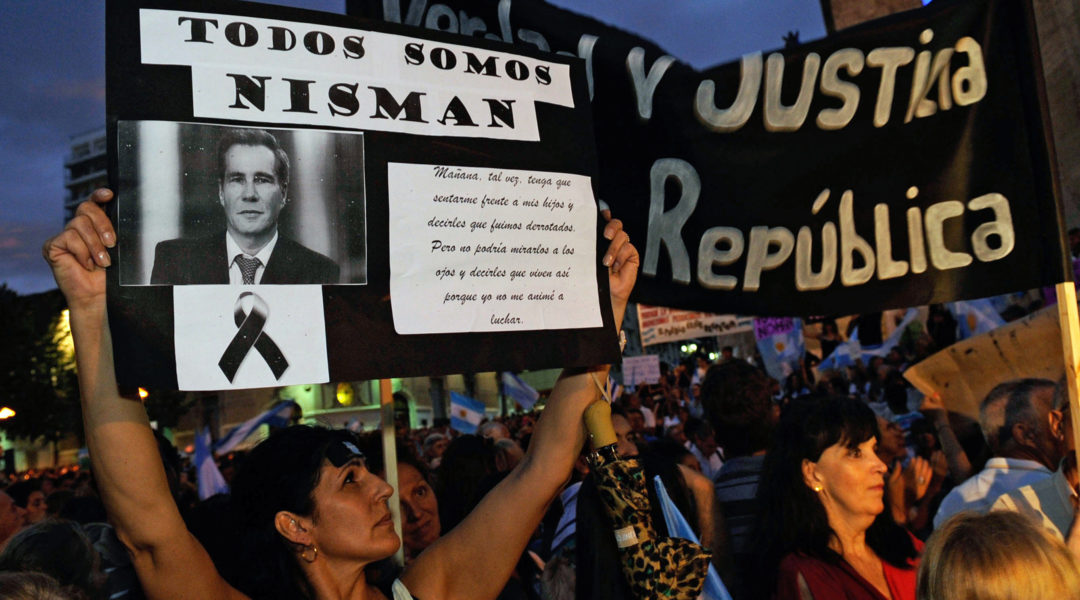 A woman holding a signs with prosecutor Alberto Nisman's portrait in Rosario, Argentina on Feb. 18, 2015. (STR/AFP via Getty Images)