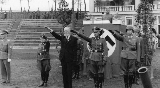 Leon Rupnik, wearing a suit, giving the Nazi salute with German soldiers in Slovenia sometime between 1943 and 1945. (Archives of the Republic of Slovenia)