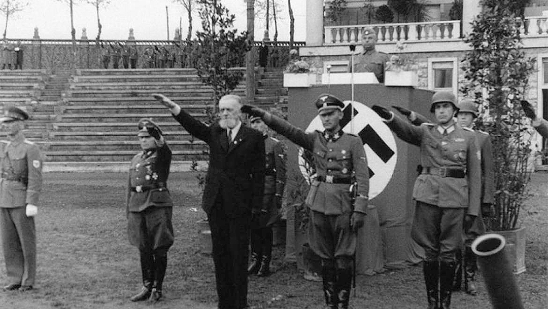 Leon Rupnik, wearing a suit, giving the Nazi salute with German soldiers in Slovenia sometime between 1943 and 1945. (Archives of the Republic of Slovenia)