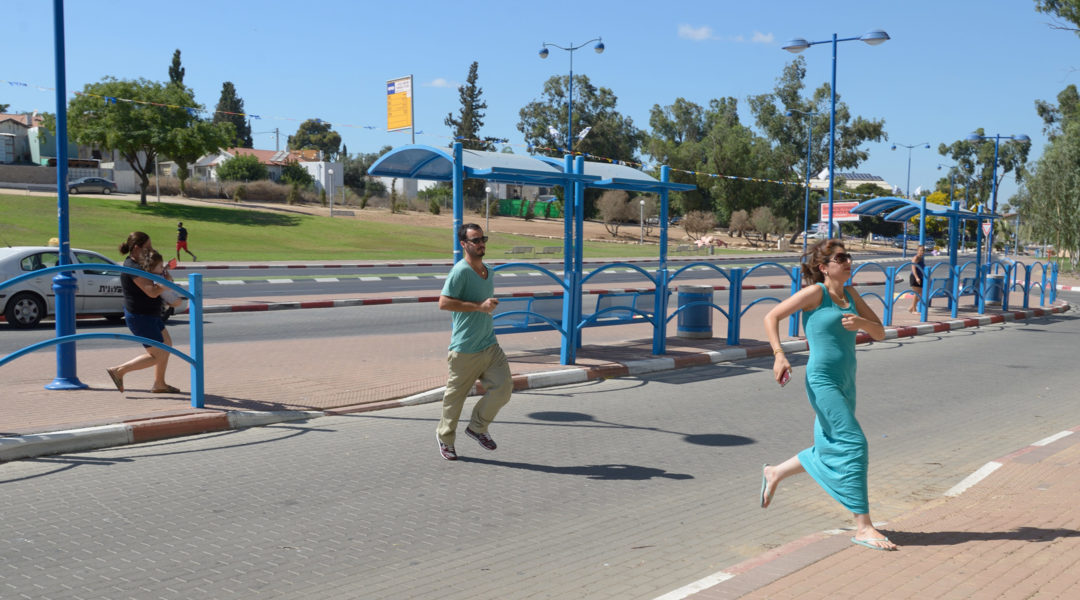 Israelis running to take cover in a shelter as a Red Alert Siren is heard in the Southern city of Sderot, on July 17, 2014. (NurPhoto/Corbis via Getty Images)