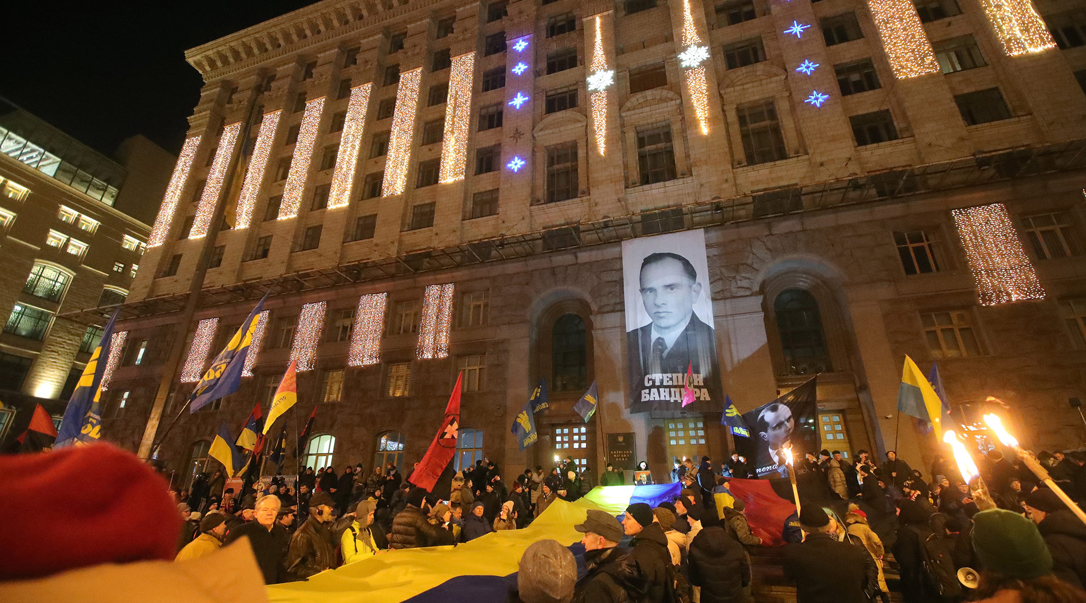 Marchers rally outside the Kyiv City State Administration during a torchlight procession honoring Stepan Bandera, in Kyiv, Ukraine on Jan. 1, 2020. (Pavlo_Bagmut/ Ukrinform / Barcroft Media via Getty Images)