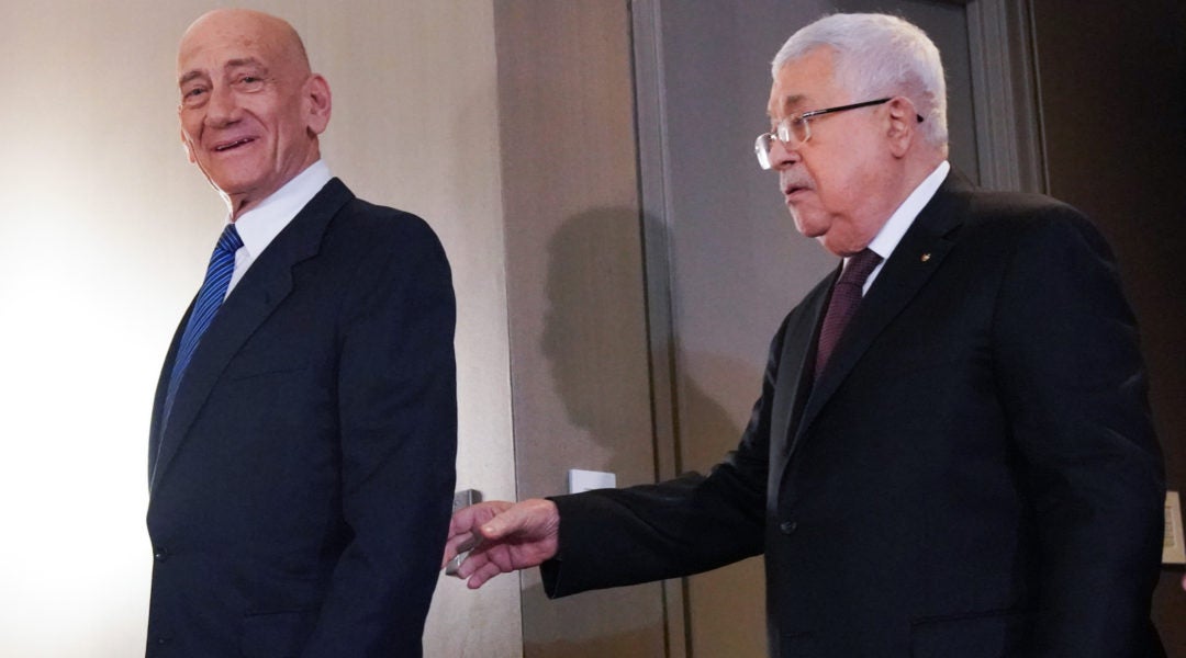 Palestinian Authority President Mahmoud Abbas and former Israeli Prime Minister Ehud Olmert arrive for a press conference on U.S. President Donald Trump's Israeli-Palestinian peace plan on February 11, 2020, in New York. (Bryan R. Smith/Getty Images)