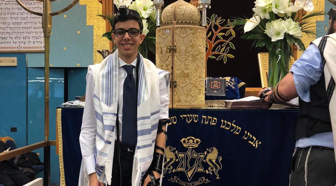 Ruben Golran, a Milanese bar mitzvah boy, upon putting on tefillin for the first time. (Courtesy of the Golran family)