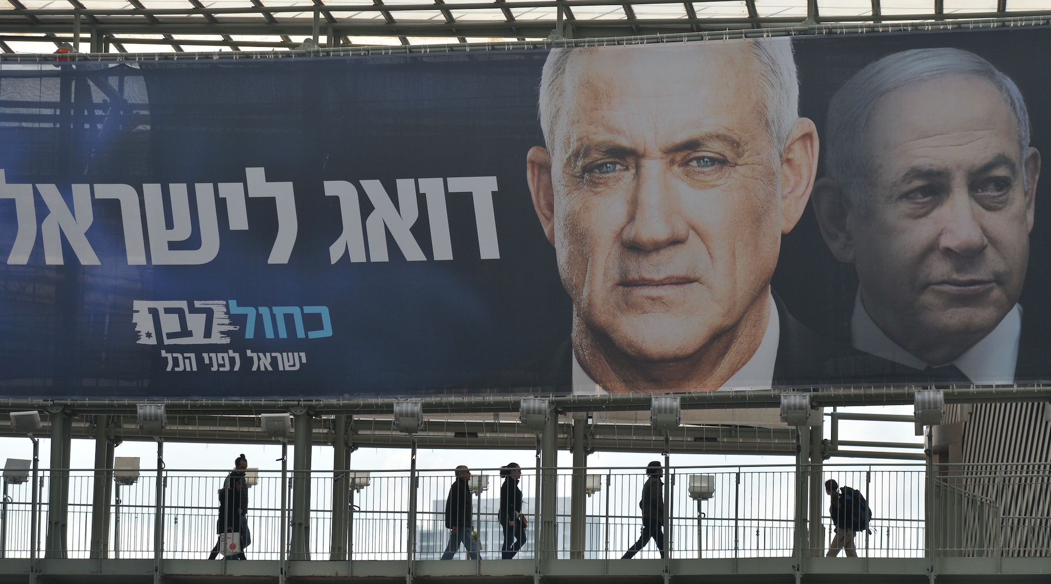 A campaign billboard in Ramat Gan, a suburb of Tel Aviv, featuring Blue and White party leader Benny Gantz in front of Israeli Prime Minister Benjamin Netanyahu. (Artur Widak/Getty Images)