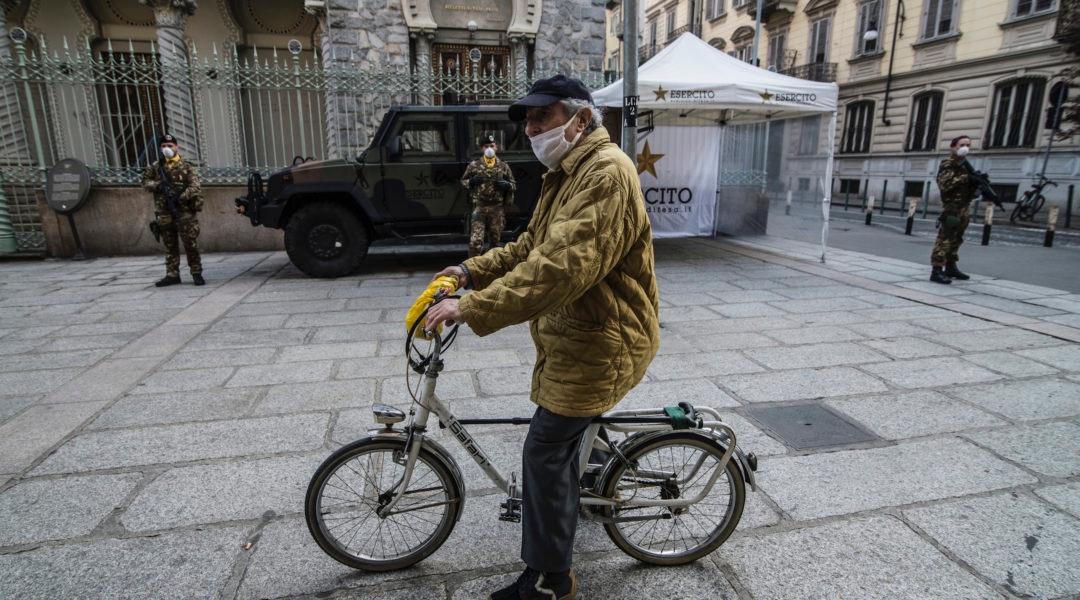 A man rides a bike in front of a synagogue in Turin, Italy, March 18, 2020. (Stefano Guidi/Getty Images)