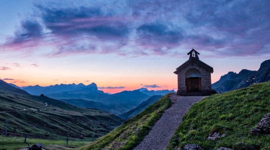 A small chapel close to Pordoi pass in the Canazei area at sunrise with the Setsas mountains in the distance. (Frank Bienewald/Getty Images)