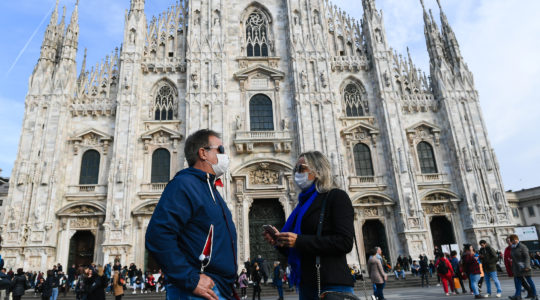 Man and woman standing outside the Milan Cathedral with protective masks and sanitizing gels in Milan, Italy on Feb. 23,2020 (Andrea Diodato/NurPhoto via Getty Images)