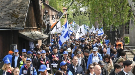 Participants of the March of the Living event exiting a gate in the former Nazi camp Auschwitz in Poland, May 2, 2019. (Courtesy of the International March of the Living)