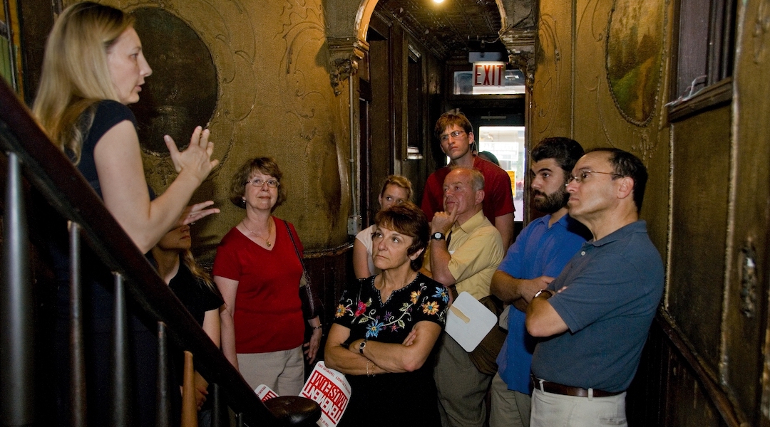 A group takes a tour of the Tenement Museum, which tells the stories of Jewish and other immigrants to New York. The museum has closed temporarily and shedded most of its staff. (Courtesy of the Tenement Museum)