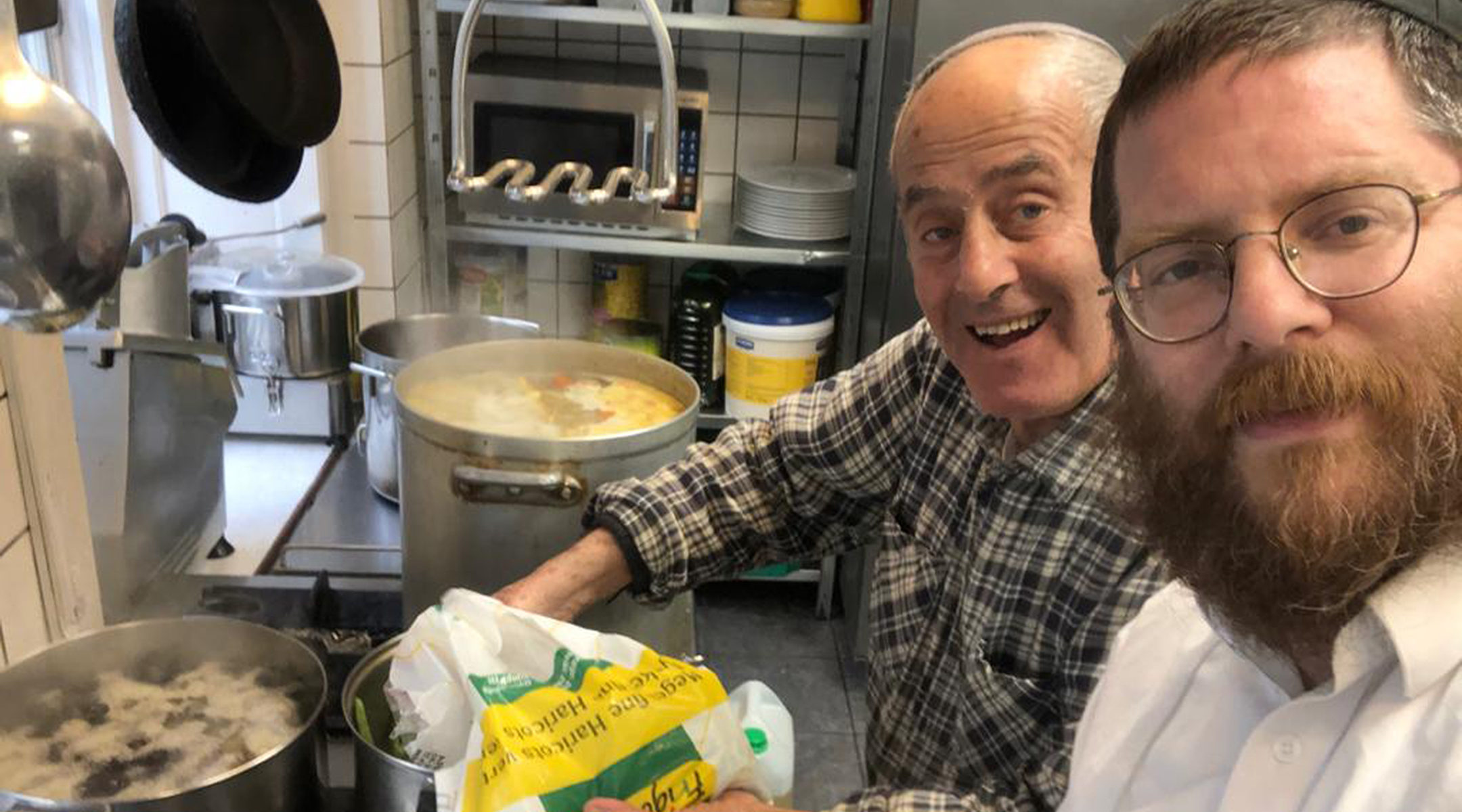 Immanuel Chanuka, left, and Rabbi Yitzi Loewenthal cooking together at the Chabad House of Copenhagen, Denmark in 2019. (Courtesy of Chaabd Denmark)