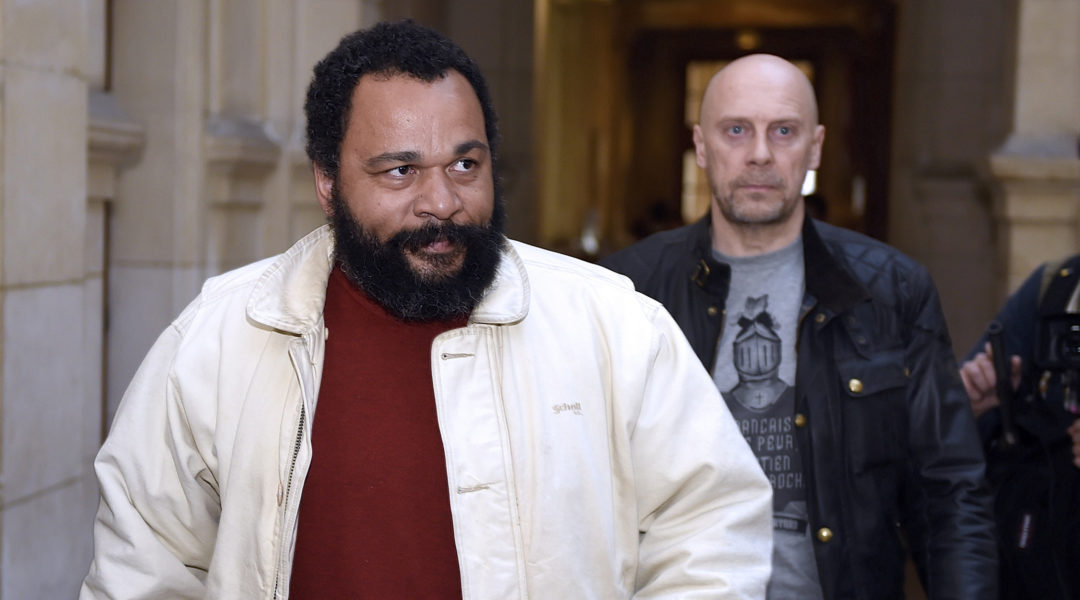 Dieudonne M'bala M'bala, left, and Alain Soral arriving at the Paris courthouse on March 12, 2015, for Soral's trial for inciting hatred against Jews. (Loic Venance/AFP via Getty Images)