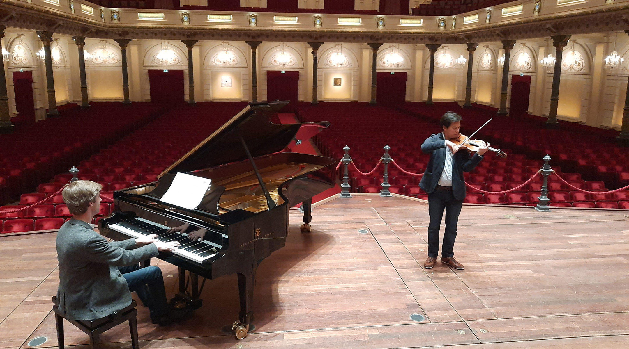 Pianist Marc Wielart and violinist Eduardo Paredes Crespo playing Israel's national anthem at the Concergebouw hall in Amsterdam, the Netherlands in April 2020. (Courtesy of Barry Mehler)