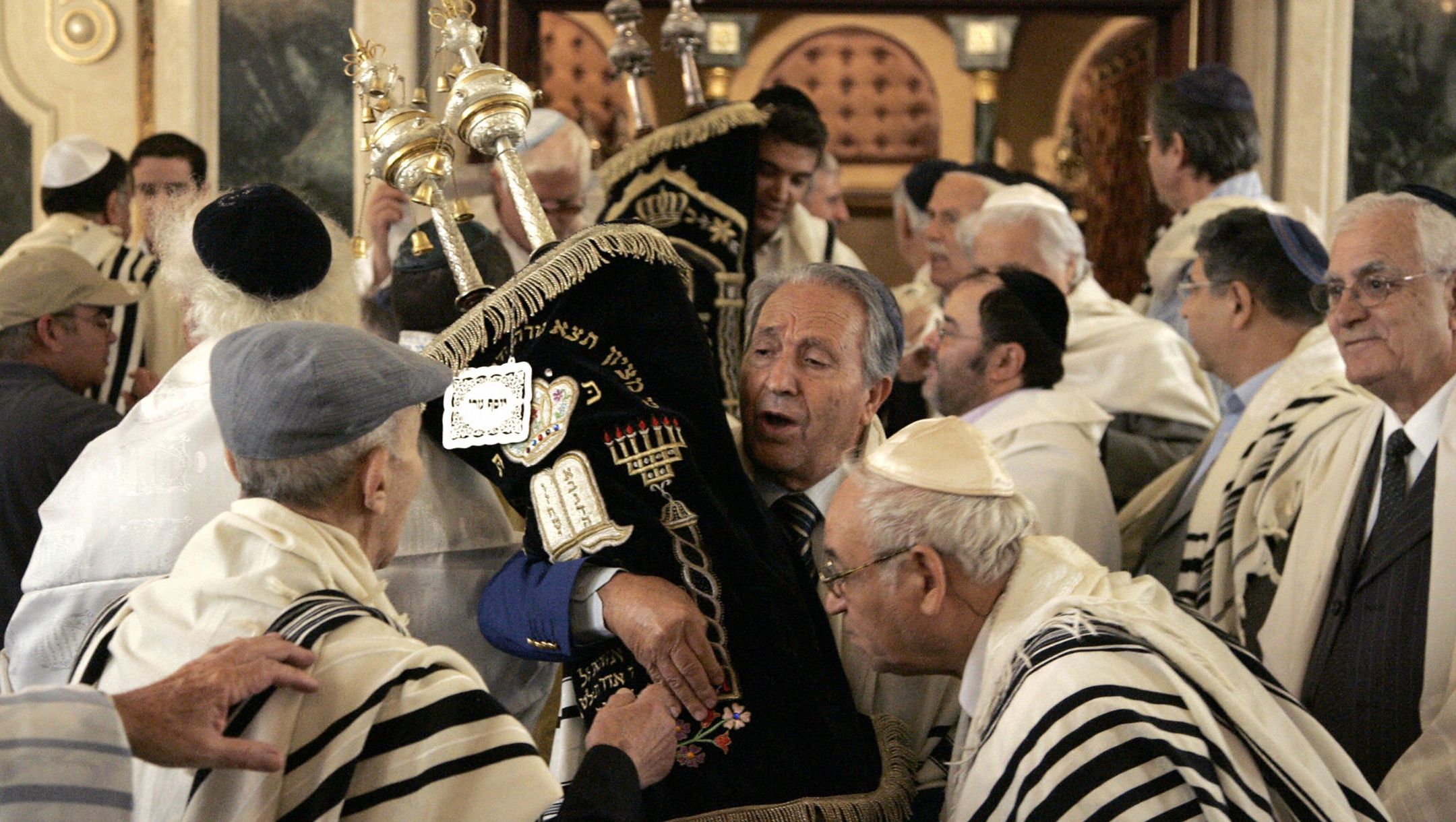 Members of Morocco’s Jewish community kiss Torah scrolls at Simchat Torah at the Great Synagogue of Casablanca, Morocco on Oct. 5, 2007. (Abdelhak Senna/AFP via Getty Images)