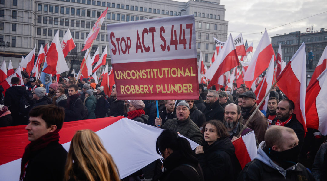 Demonstrators protesting US legislation requiring the return of property stolen from Jews in the Holocaust in Warsaw, Poland on Nov. 11, 2019. (Omar Marques/SOPA Images/LightRocket via Getty Images)