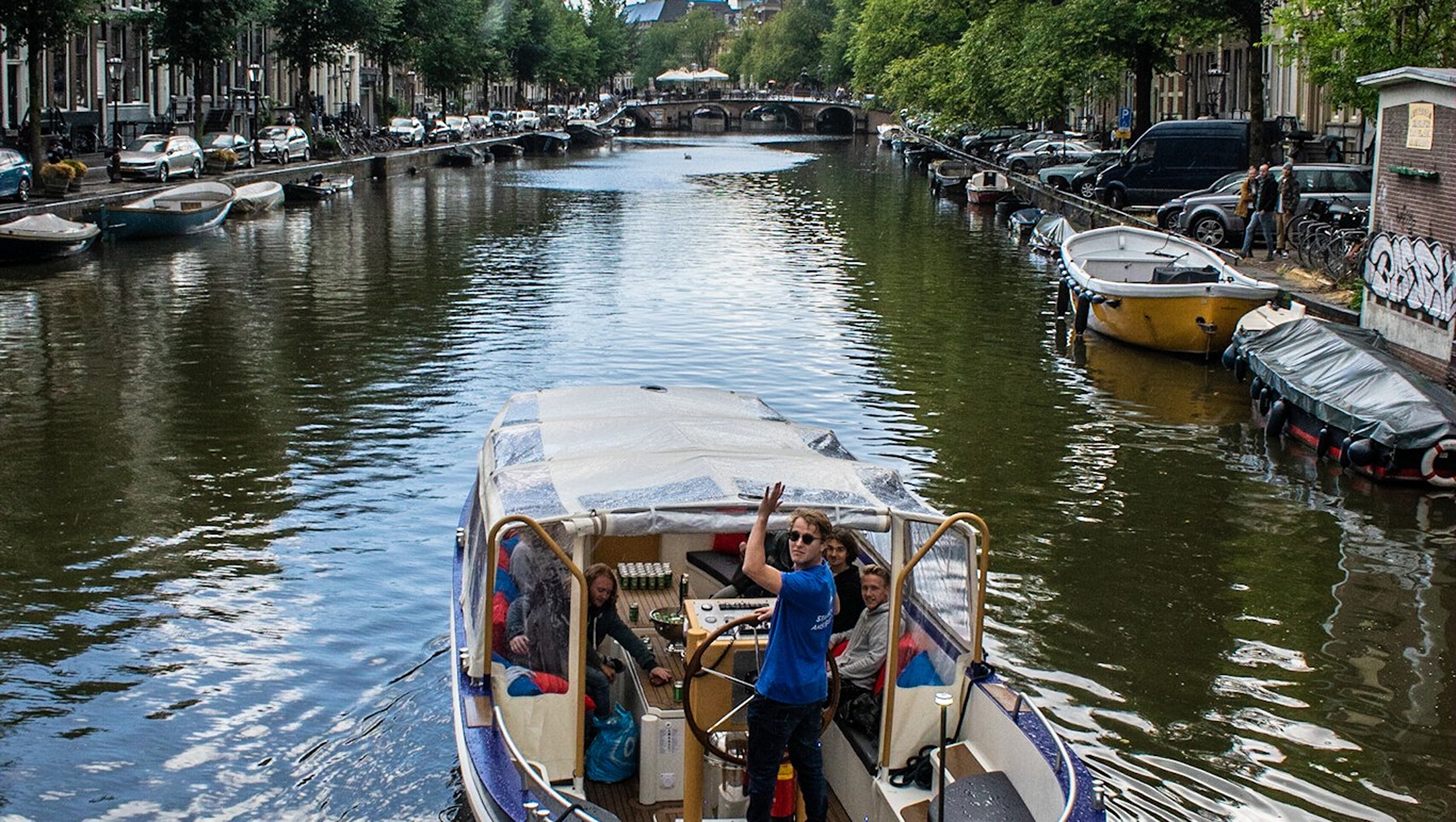 A boat belonging to the We Are Amsterdam canal tour operator sails in the center of Amsterdam, the Netherlands in 2019. (Courtesy of We Are Amsterdam)