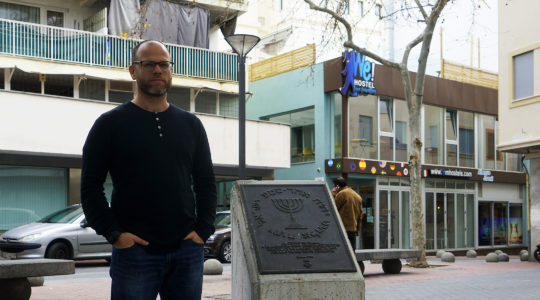 Dani Rotstein stands next to a monumnet commemorating the Jews of Palma de Mallorca, Spain on Feb. 13, 2019. (Cnaan Liphshiz)