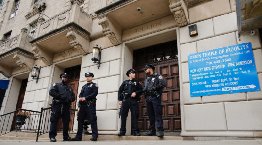 NYPD officers stand guard at the door of the Union Temple of Brooklyn, after it was grafittied, in New York City on November 2, 2018. (Kena Betancur/AFP via Getty Images)