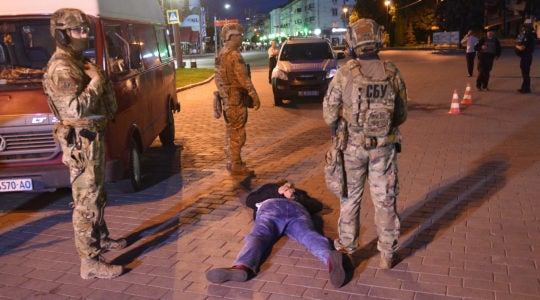 Ukrainian police officers detain a suspected hijacker in Lutsk, Ukraine on July 21, 2020. (Yuriy Dyachyshyn/AFP via Getty Images)