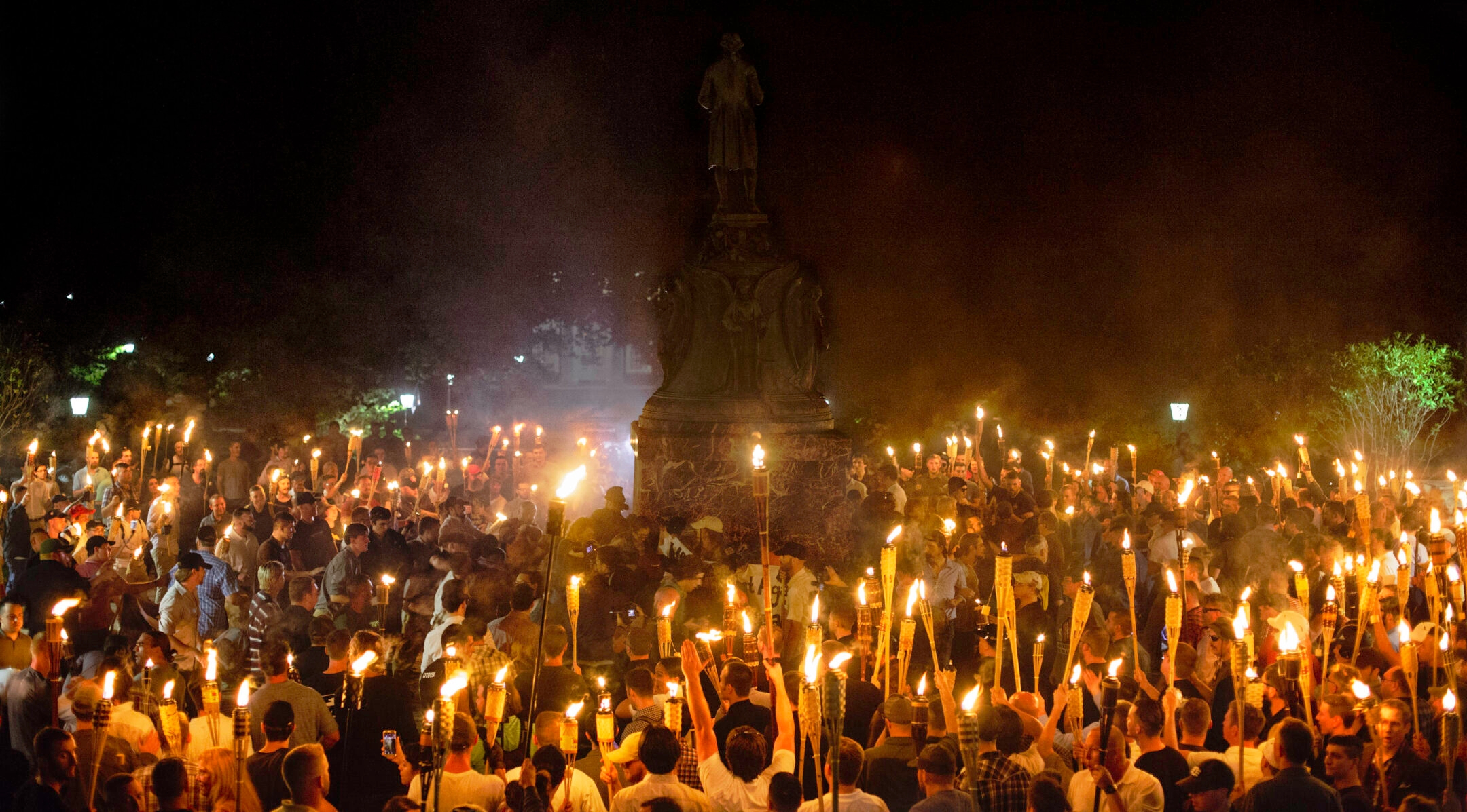 Neo-Nazis and white supremacists encircle counterprotesters at the base of a statue of Thomas Jefferson after marching through the University of Virginia campus with torches in Charlottesville, Va., Aug. 11, 2017. (Shay Horse/NurPhoto via Getty Images)