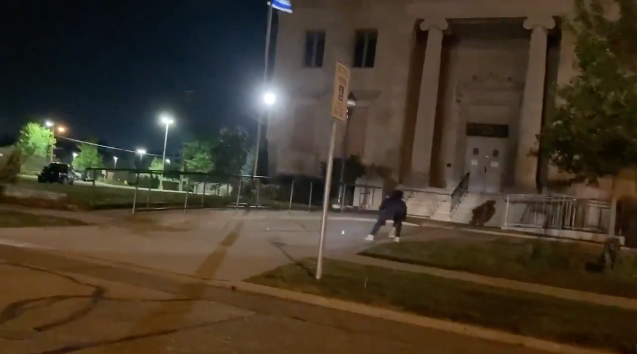 Someone sprays graffiti reading 'Free Palestine' on the driveway of Beth Hillel Temple in Kenosha, Wisconsin on Wednesday, Aug. 26. (Screenshot from YouTube)