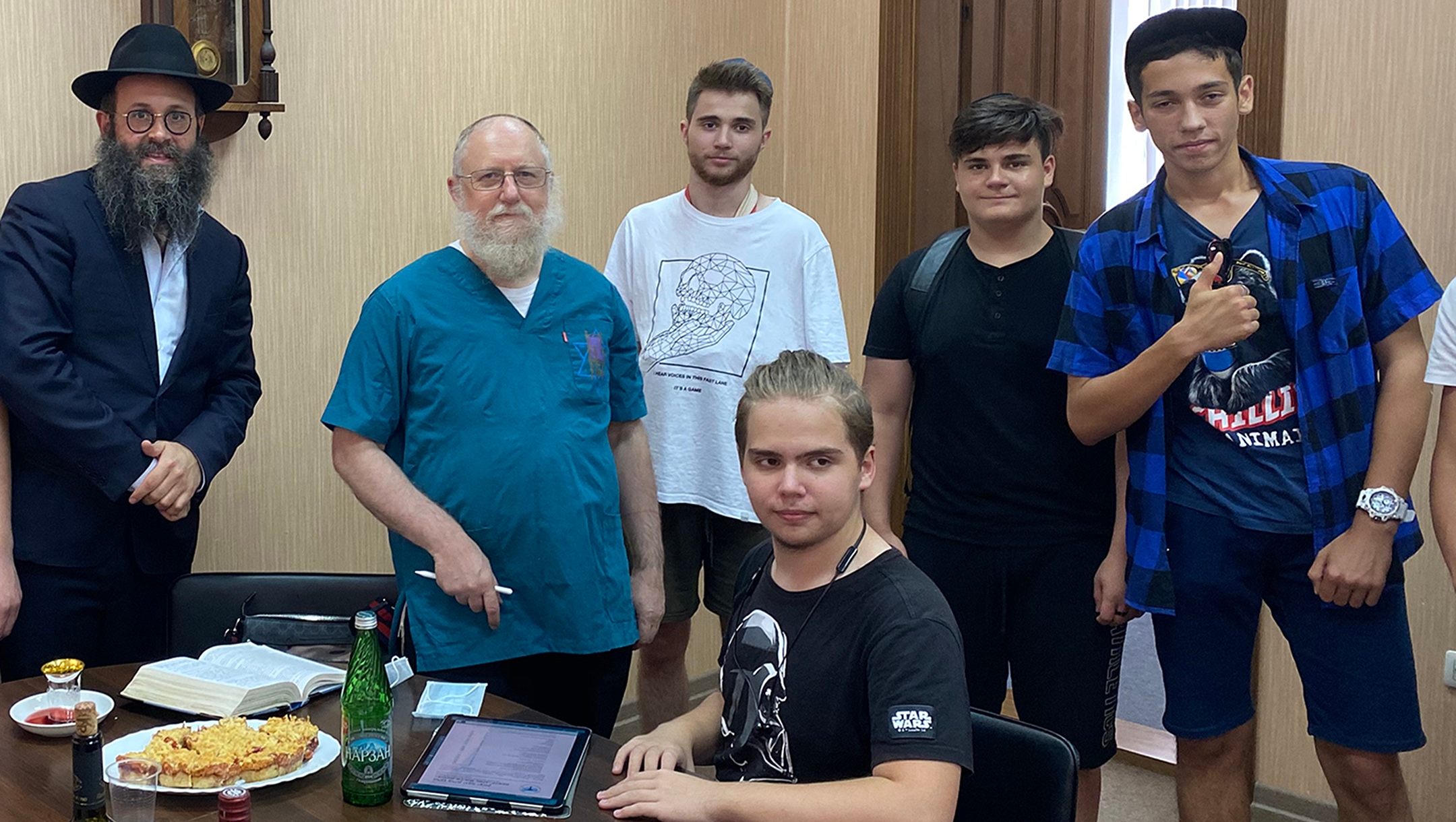 Rabbi Chaim Danzinger, left, introduces Dr. Yeshaya Shafitto younger Jews awaiting circumcision at the synagogue of Rostov-on-Don, Russia on July 27, 2020. (Courtesy of the Jewish Community of Rostov.)