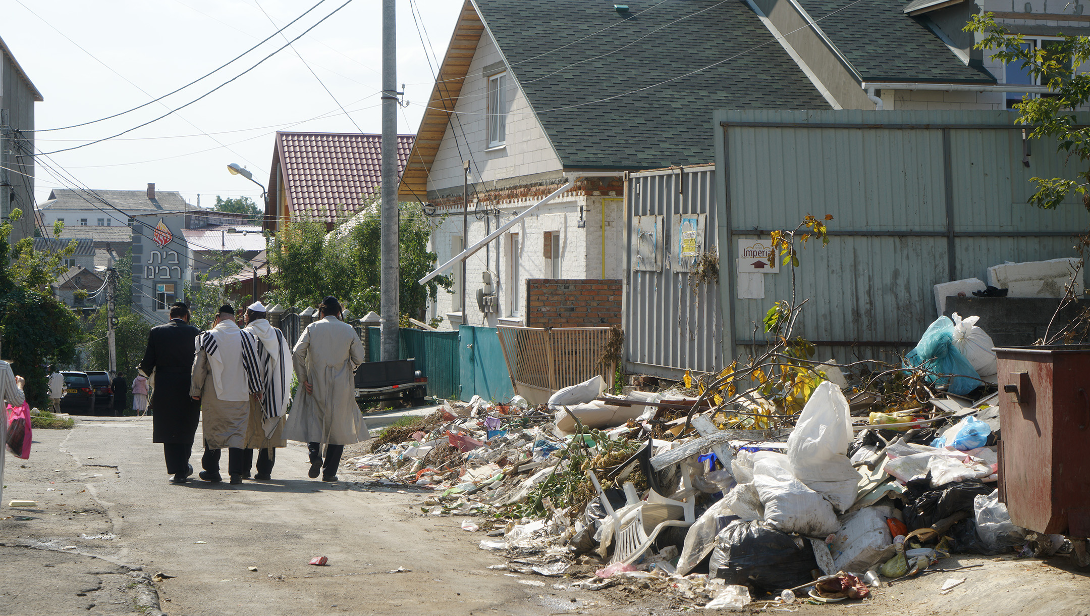 Jewish men walk down a street in the Pushkin area of Uman, Ukraine of ‎Sept. ‎9, ‎2017. (Cnaan Liphshiz)