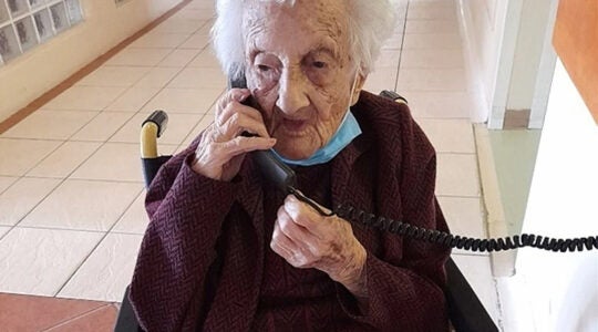 Rosalie Wolpe speaks to a relative on the phone on her 111th birthday at a retirement home in Cape Town, South Africa on Aug. 25, 2020. (David Wolpe)