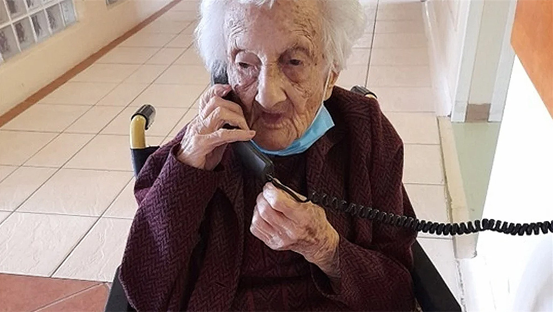 Rosalie Wolpe speaks to a relative on the phone on her 111th birthday at a retirement home in Cape Town, South Africa on Aug. 25, 2020. (David Wolpe)