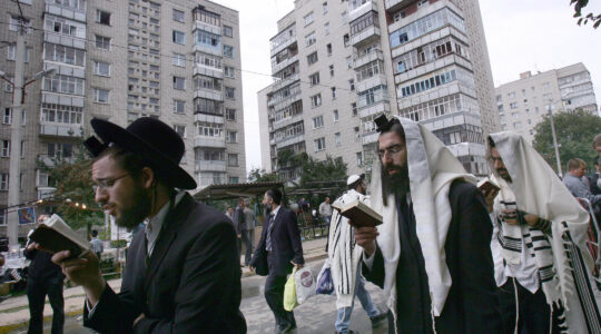 Jews pray on a street near the tomb of Reb Nachman of Breslov in Uman, Ukraine, on Sept. 20, 2006. (Menahem Kahana/AFP via Getty Images)