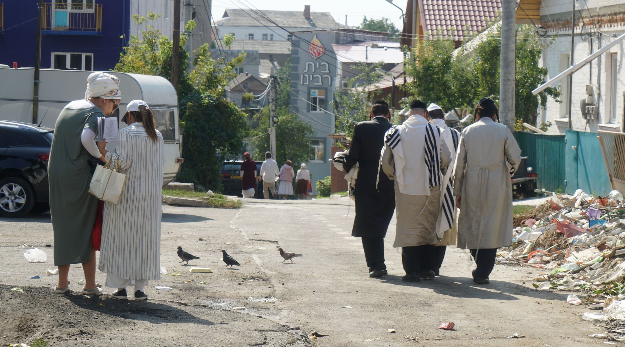 Jews walk down an alley leading to Pushkina Street in Uman, Ukraine on Sept. 8, 2017. (Cnaan Liphshiz)