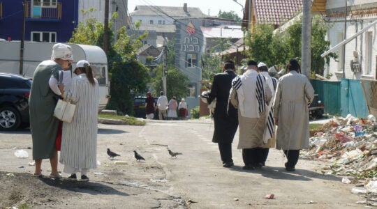 Jews walk down an alley leading to Pushkina Street in Uman, Ukraine on Sept. 8, 2017. (Cnaan Liphshiz)