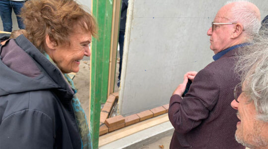 Jacqueline van Maarsen smiles as she examines the first memorial brick in the Names Monument of Amsterdam, the Netherlands on Sept. 23. (Courtesy of Holocaust Names Monument Netherlands.)