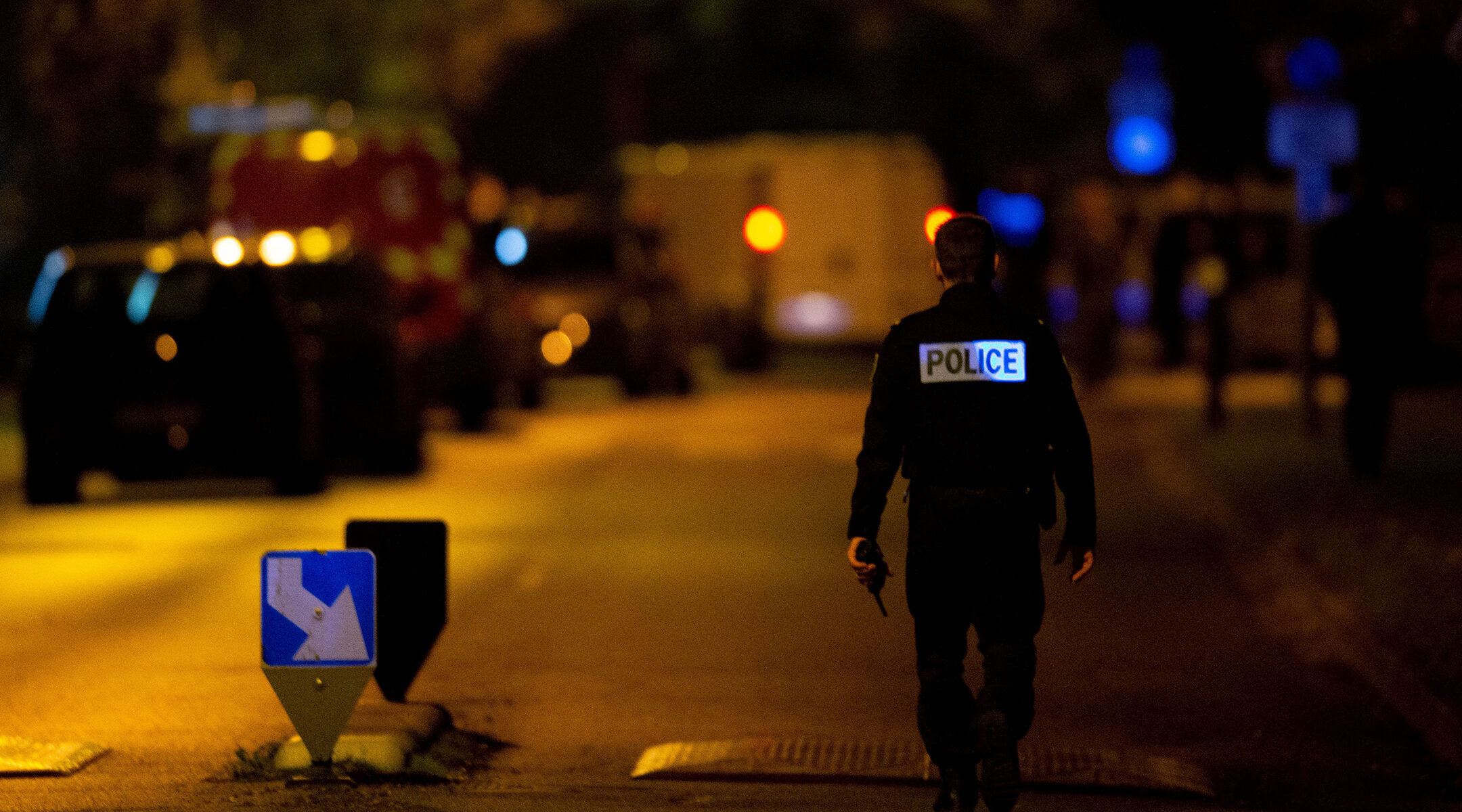 A police officer walks into the scene of the murder of a history teacher in Éragny, France on Oct. 16, 2020. (Abdulmonam Eassa/AFP via Getty Images)