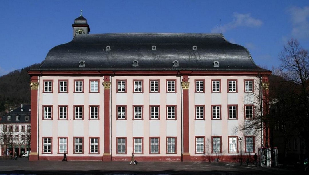 Pedestrians walk past a campus building at the University of Heidelberg, Germany on March 1, 2004. (Wikimedia Commons)