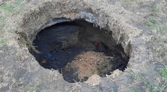 A pit that rainfall exposed at a former Jewish cemetery in Iasi, Romania in October 2020, (Dan Acostioaiei)