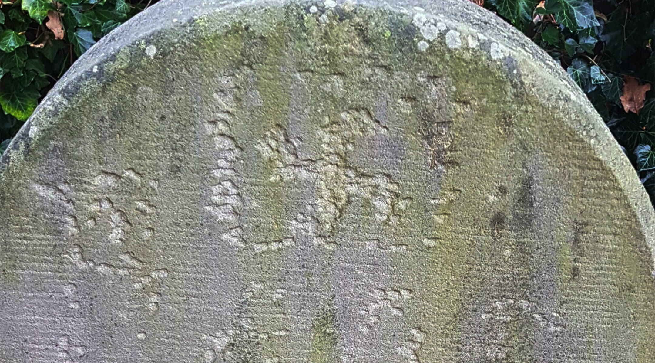 A swastika carved into a headstone at the Jewish cemetery of Haren, Germany in November 2020. (Courtesy of the Jewish Community of Haren/Eli Nahum/Monitoring Antisemitism Worldwide)