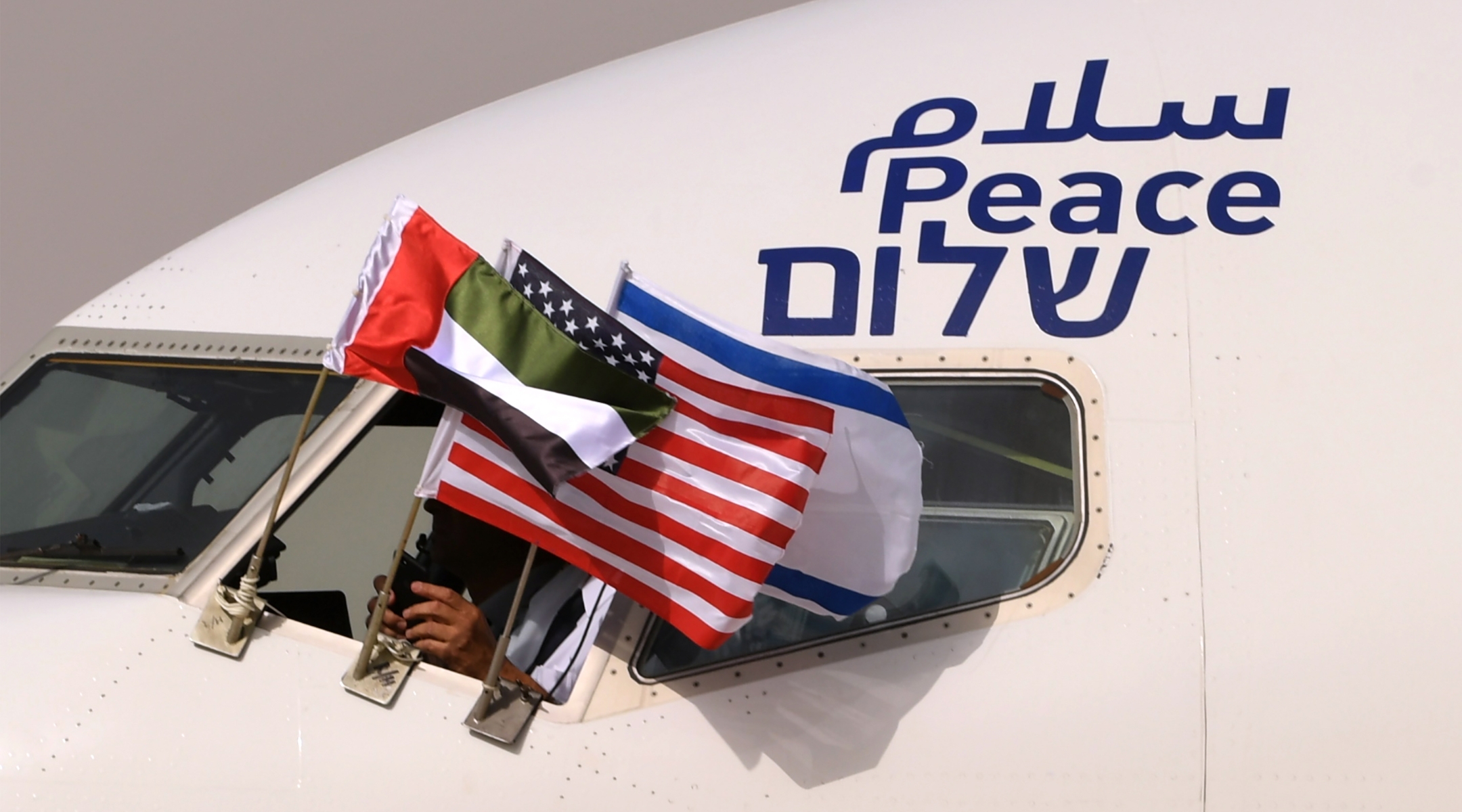 An Israeli El Al airplane flying the flags of Israel, the United Arab Emirates and the United States, and bearing the word "peace" in Arabic, English and Hebrew, arrives at the Abu Dhabi airport after flying from Tel Aviv on August 31, 2020. (Karim Sahib/AFP via Getty Images)