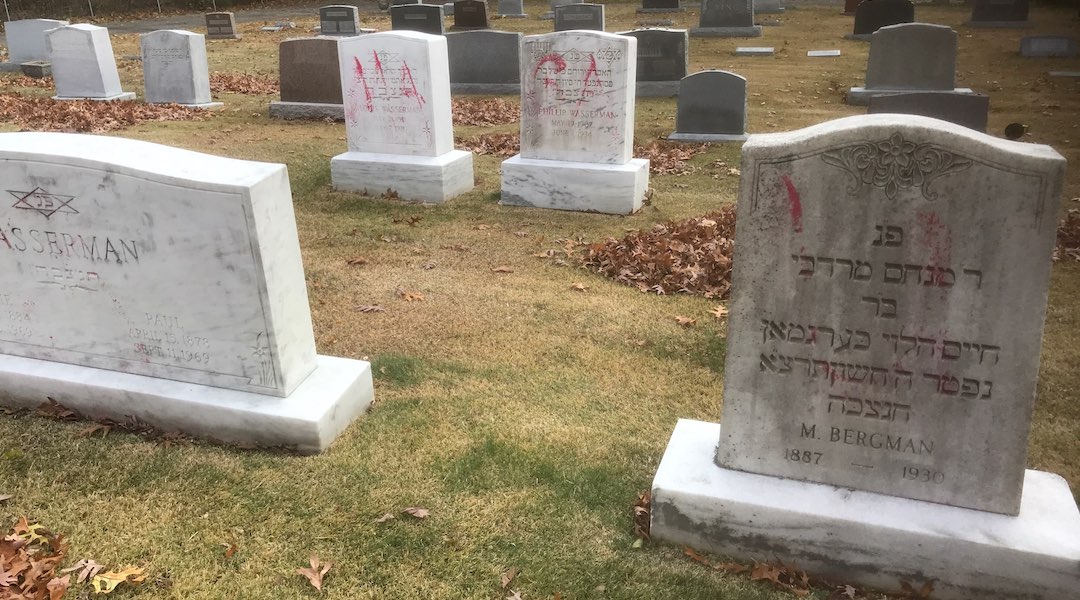 Graves are tagged with graffiti reading "MAGA" at a Jewish cemetery in Grand Rapids. (Courtesy of the ADL)