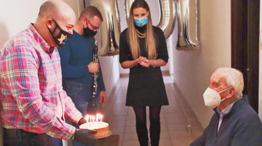 Jozef Walaszczyk, right, receives a cake on his 101st birthday in Warsaw, Poland on Nov. 12, 2020. (From the Depths)