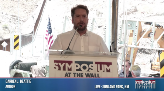 Darren Beattie, the former white house speechwriter who attended a conference with white supremacists, speaks at a "Symposium at the Wall" in 2019. (Screenshot)