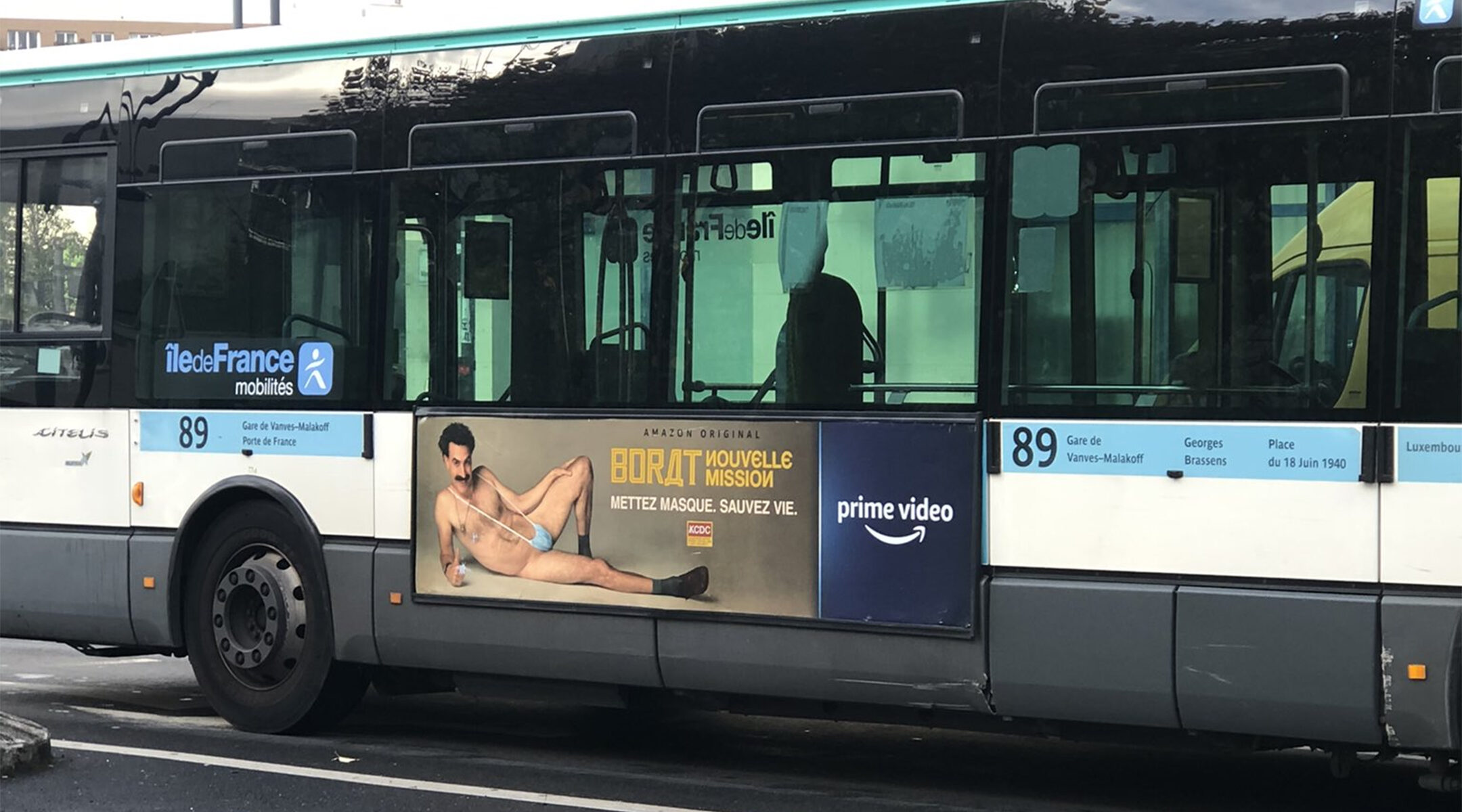 A RATP bus with a billboard of Sacha Baron Cohen wearing a ring with the word Allah on it moves through Paris, France on Nov. 2, 2020. (Courtesy of @firehairedreamr/Twitter)