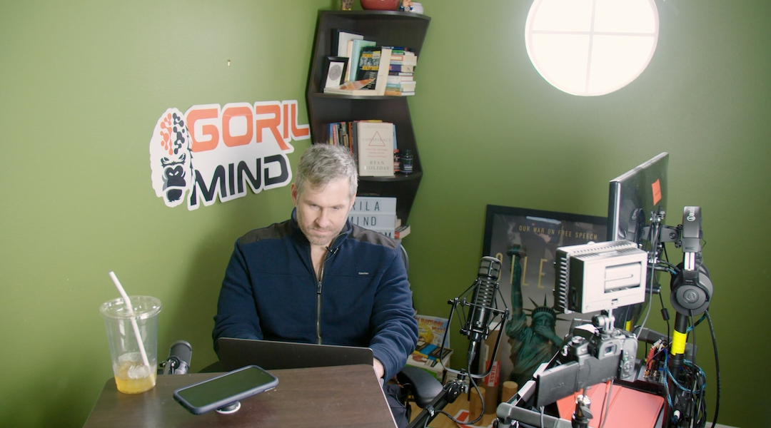 Mike Cernovich, a conspiracy theorist, works at his laptop in the documentary. (Courtesy of Lombroso)