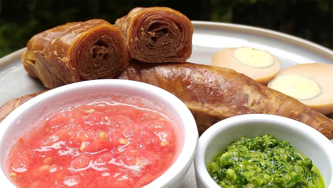 Served with crushed tomato and zhug, a spicy corriander pesto, jachnun is a weekend delicacy for Yemenite Jews. (Courtesy of Gal Garber)