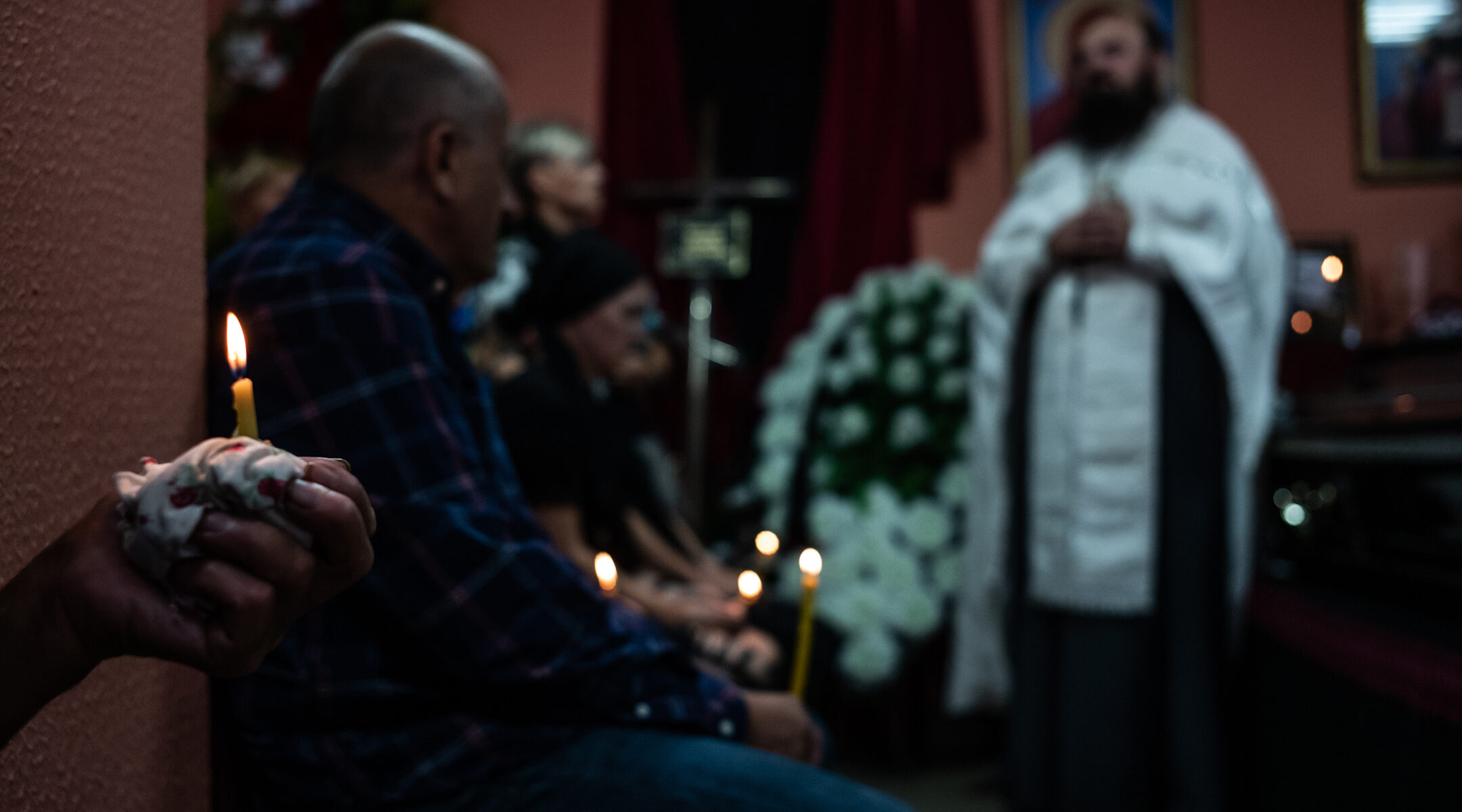A priest prays at a funeral in Maladzyechna, Belarus on August 25, 2020. (Misha Friedman/Getty Images)