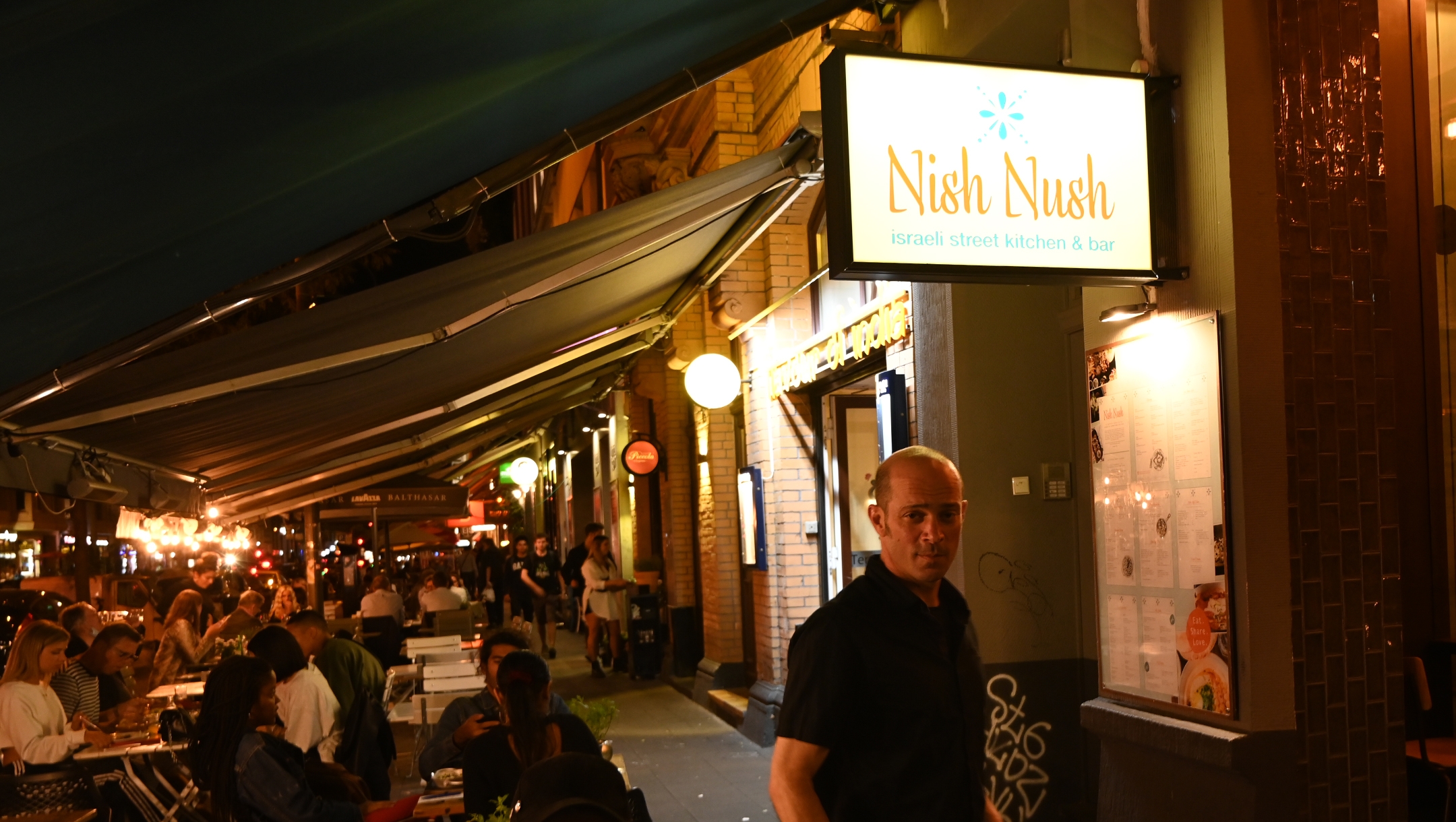 Sharon Katz enters his hummus restaurant NishNush in Cologne, Germany on Aug. 25, 2020. (Cnaan Liphshiz)