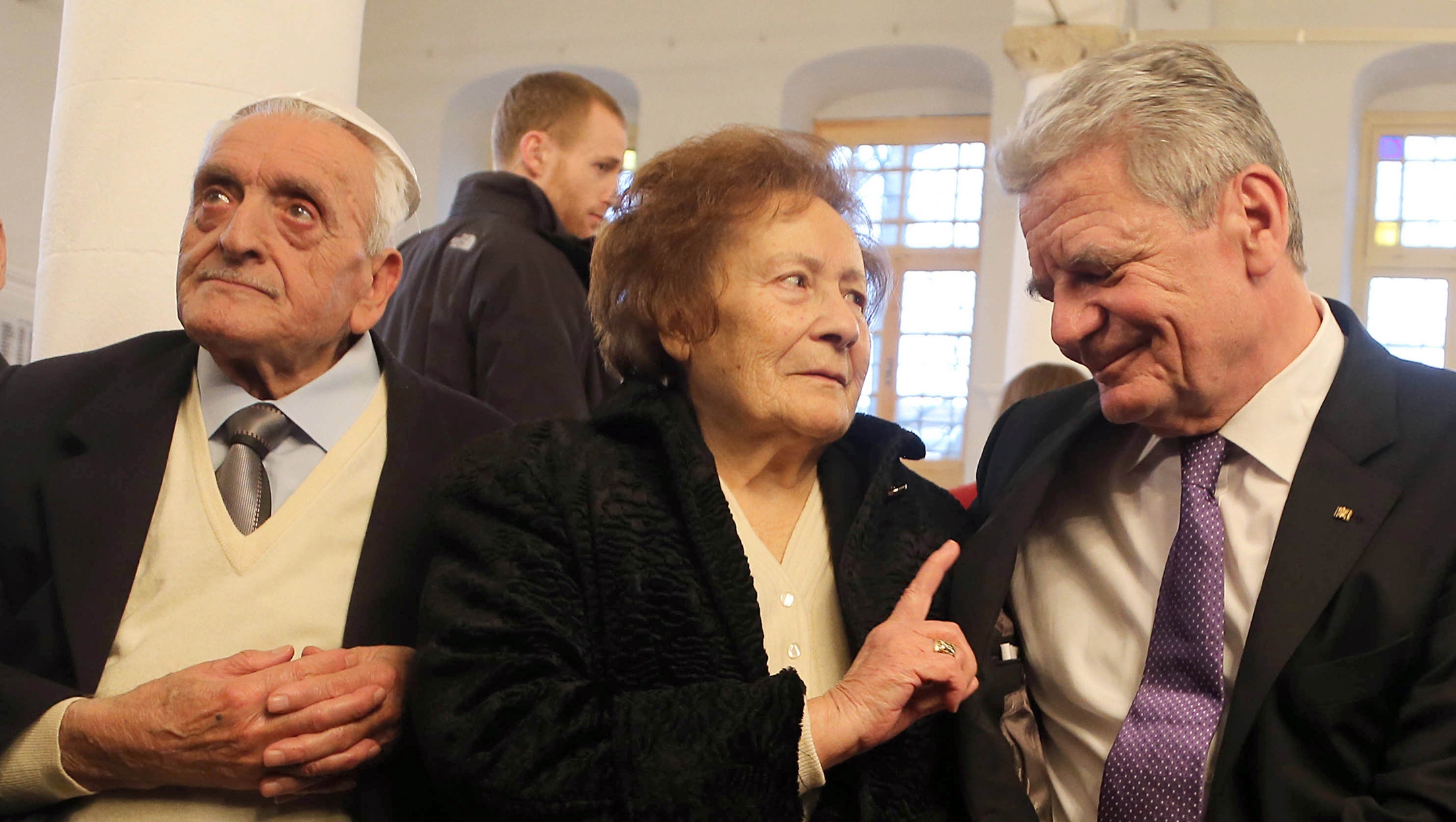 Esther Cohen sits near her husband Samuel, left, and German President Joachim Gauck in Ioannina, Greece on 07 March 2014. (Wolfgang Kumm/picture alliance via Getty Images)