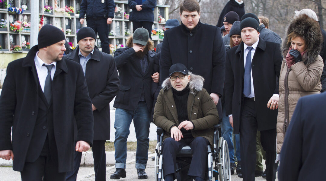 Gennady Kernes, in a wheelchair, attends the funeral of his associate and close friend, businessman Yuri Diment, at the Jewish cemetery of Kharkiv, Ukraine on Feb. 26, 2016. (Konstantin Cherginsky/TASS via Getty Images)